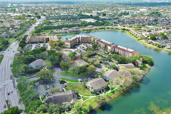Aerial view of a residential apartment complex near a lake.