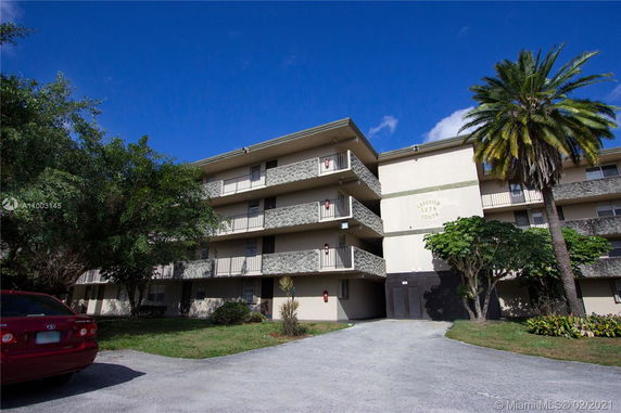 Front view of a multi-story residential building with balconies.