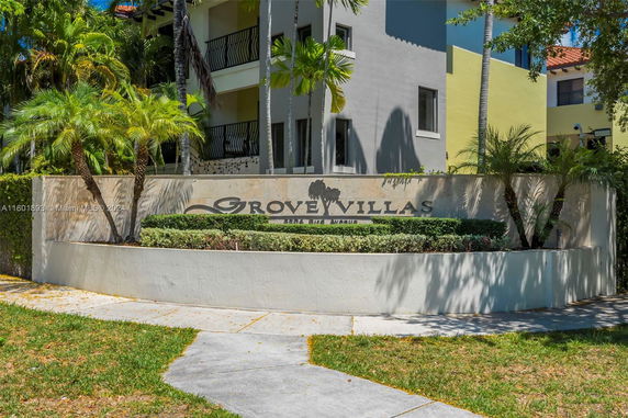 Front view of the Grove Villas building with a sign.