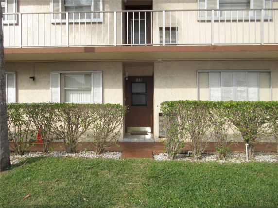 Front view of a two-story residential building with a balcony.