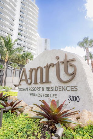Front view of a high-rise ocean resort and residences building.
