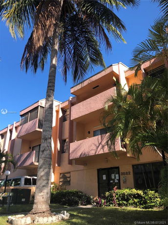 Front view of a multi-story building with balconies.