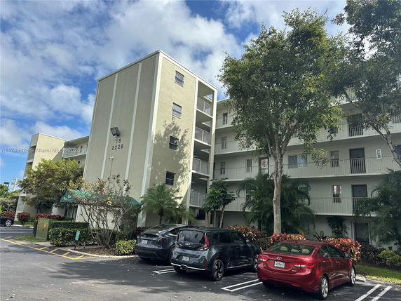 Front view of a multi-story apartment building with balconies.