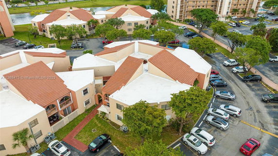 Aerial view of residential buildings with adjacent parking areas.