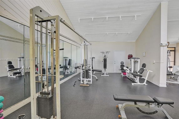 Indoor gym area with various exercise machines and equipment.