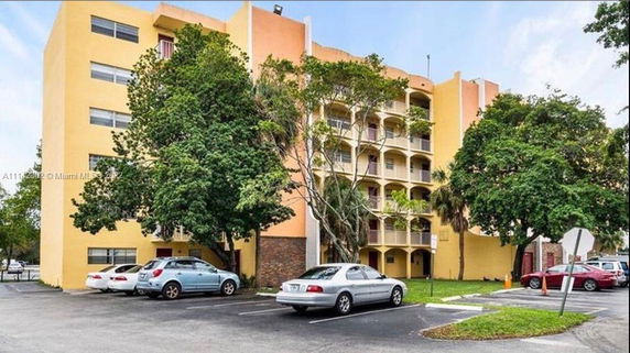 Front view of a multi-story residential building with balconies.