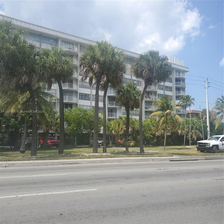Front view of a multi-story residential building with balconies.
