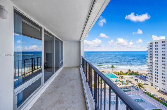 Balcony view overlooking the ocean and beach.