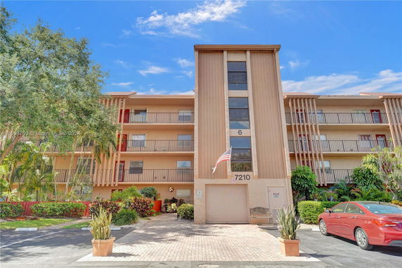 Front view of a multi-story residential building with balconies.