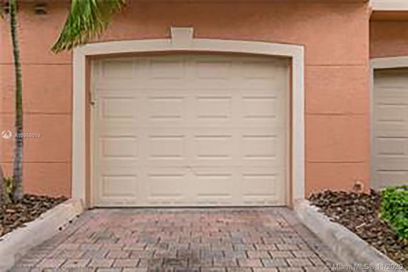 Front view of a house with a closed garage door.