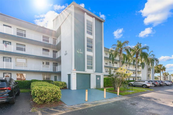 Front view of a multi-story residential building with balconies.