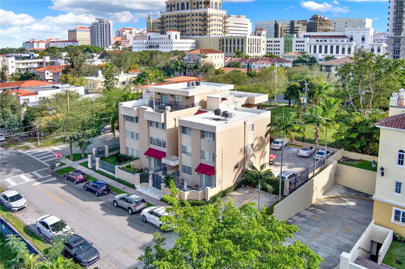 Aerial view of a residential building surrounded by urban structures.