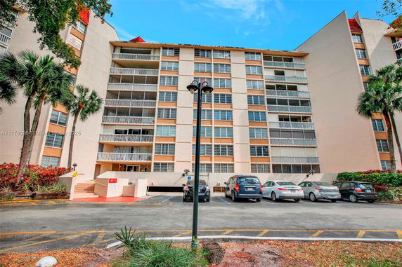 Front view of a multi-story apartment building with balconies.