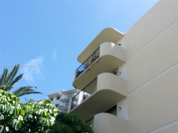 View of a building with multiple balconies and a modern design.