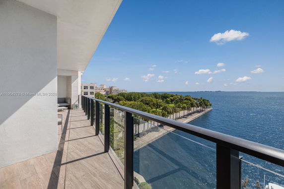 Panoramic view from a balcony overlooking a waterfront.
