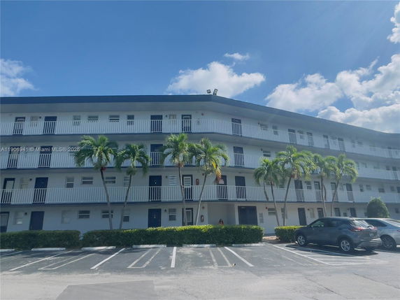 Front view of a multi-story building with balconies.