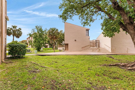 View from outside showing a modern building with a sloped roof and concrete pathway.
