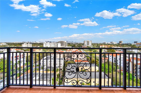 Panoramic view from a balcony showing cityscape and buildings.