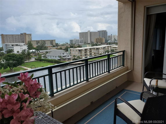 View from a balcony overlooking a waterway and surrounding buildings.