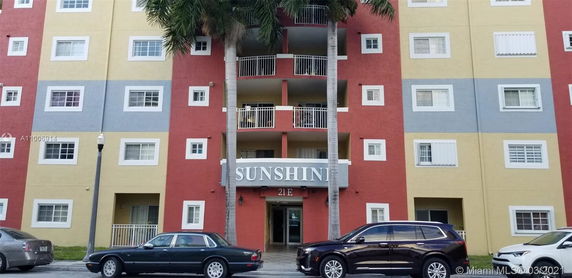 Front view of a multi-story building with colorful exterior and balconies.