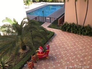 View of an outdoor swimming pool area with decorative elements like a Santa sleigh and reindeer.