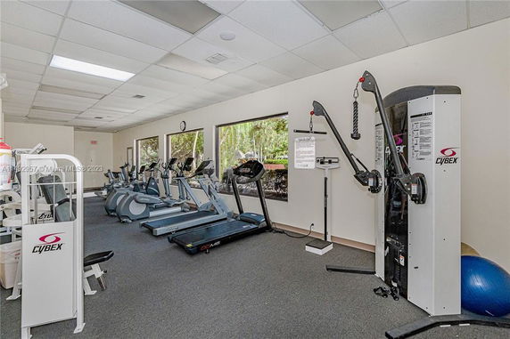 Indoor gym area with exercise equipment including treadmills and weight machines.