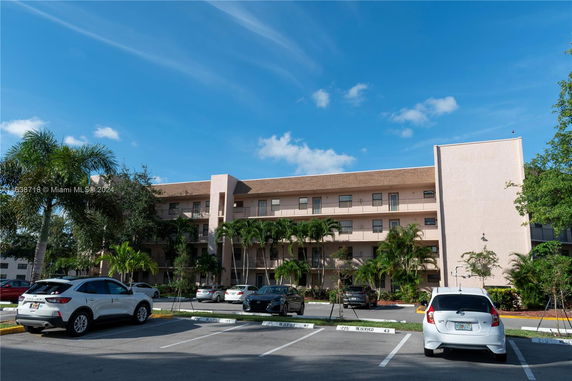 Front view of a multi-story residential building with balconies.
