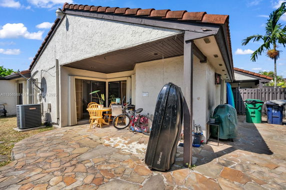 Front view of a single-story house with a covered patio area and tiled roof.
