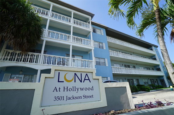 Front view of a multi-story residential building with balconies.