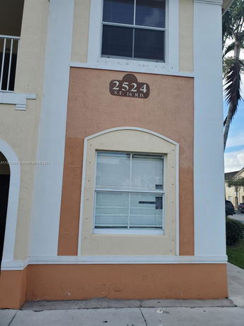 Front view of a building with an arched window and address number 2524.