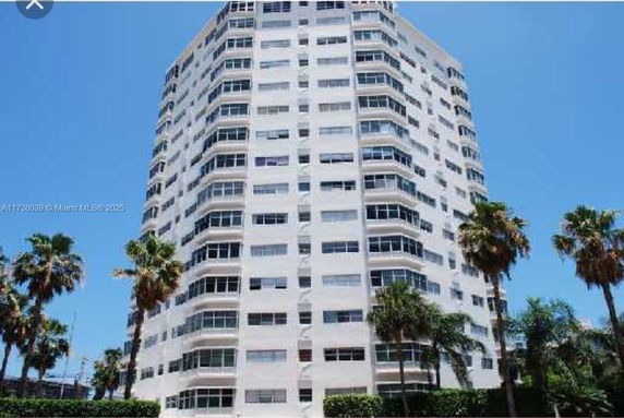 Front view of a multi-story residential building with balconies.