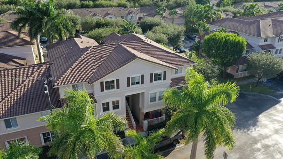 Elevated view of a multi-story residential building with tiled roof.