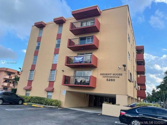 Front view of a multi-story condominium building with balconies.