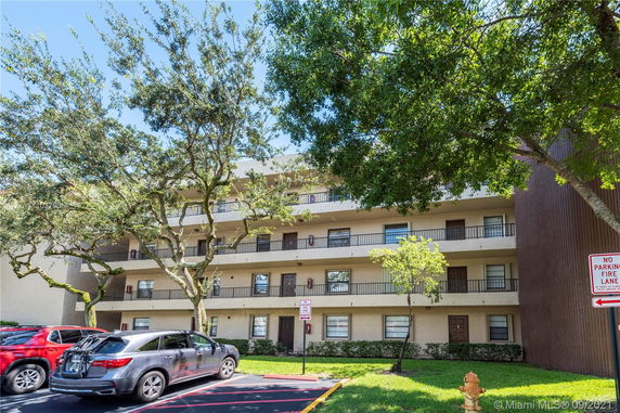Front view of a multi-story residential building with balconies.