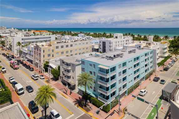 Aerial view of a coastal area with multiple apartment buildings and a nearby ocean.