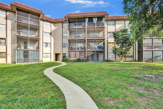 Front view of a multi-story building with balconies.