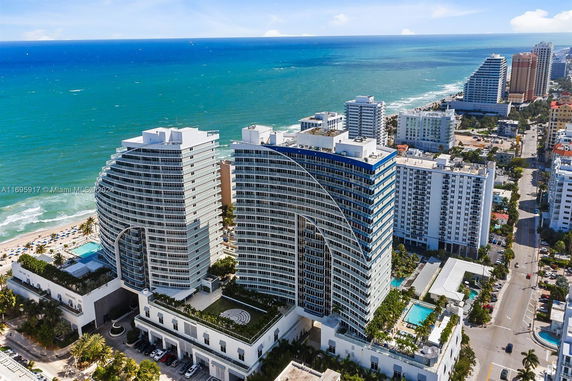 Aerial view of modern high-rise buildings near the ocean.