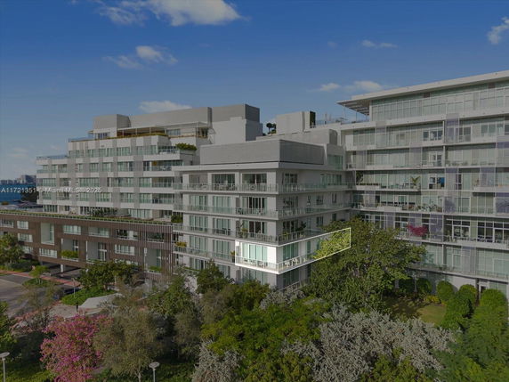 Front view of a multi-story apartment building with balconies.
