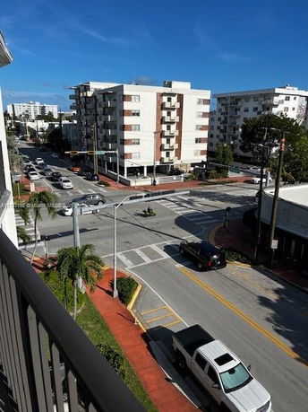 View from a building showing a street intersection with apartment buildings.