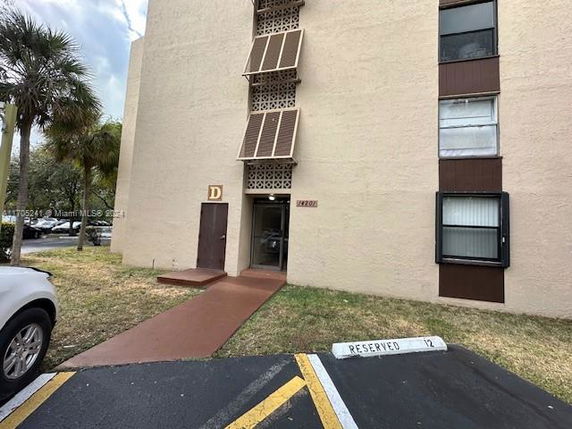 Front view of a multi-story building with small entrance area.