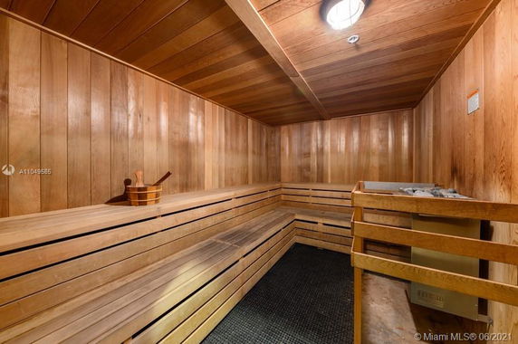 Interior view of a sauna room with wooden benches and walls.