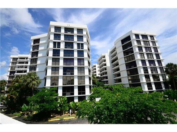 Front view of multiple modern multi-story apartment buildings.