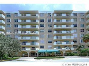 Front view of a multi-story residential building with balconies.