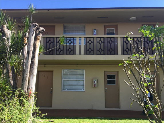 Front view of a two-story apartment building with balconies.