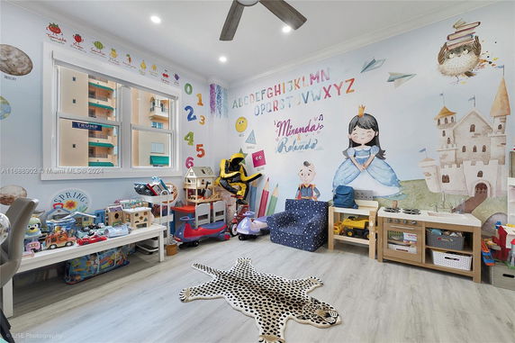 Colorful children's playroom with toys and wall murals.
