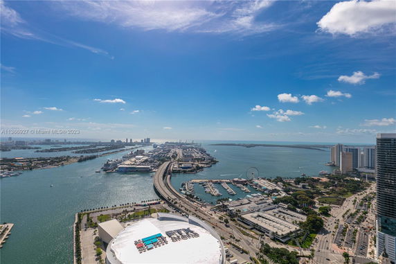 Panoramic view of a coastal city with waterways and high-rise buildings.