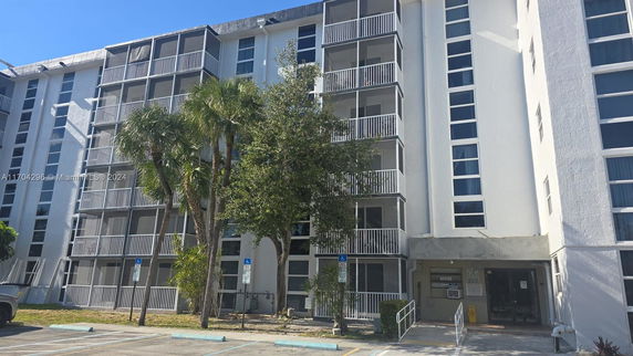 Front view of a multi-story residential building with balconies.