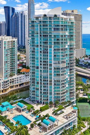 Front view of a high-rise building with numerous balconies and modern design.