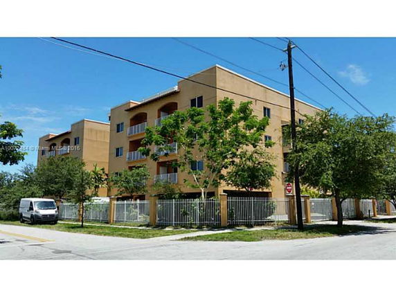 Front view of a multi-story apartment building with balconies.