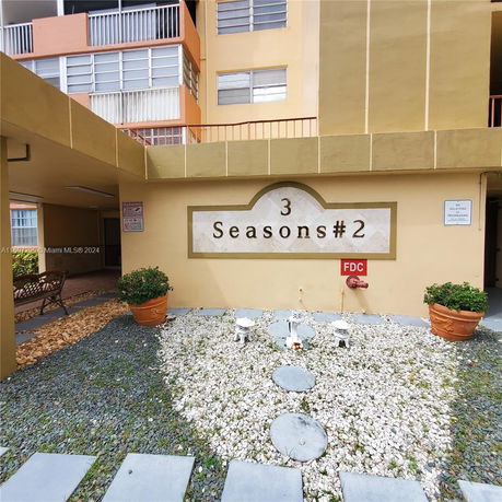 Front view of a multi-story building with a sign that reads '3 Seasons #2.'